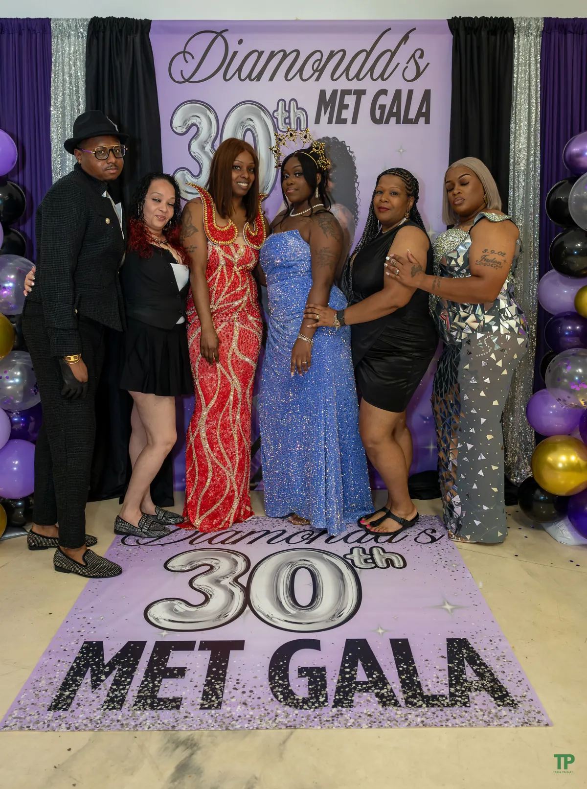 Guests posing together at Diamondd’s 30th-birthday photo backdrop